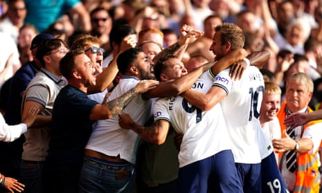 Harry Kane celebrates with his teammates and Tottenham fans after scoring his second goal.