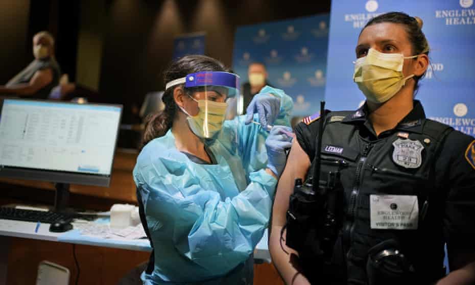 Jennifer Leeman, an officer in New Jersey, receives a Covid-19 vaccine on 14 January. 