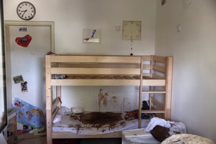 Toys lie on a bunk bed with blood stains after the 7 October attack by gunmen from Palestinian militant group Hamas from the Gaza Strip, in Nir Oz kibbutz in southern Israel, 21 November