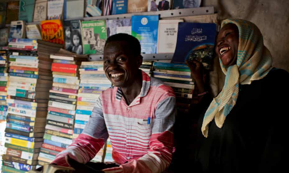 Juma Ali, 34, centre, a Christian from the Nuba Mountains in Sudan who fled to Malakal in South Sudan, in his bookshop in the camp.