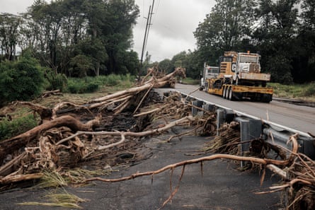 a truck drives by debris along a road