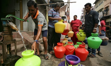 People stand in line for supplies from the daily water deliveries in Chennai where shortages have reached crisis point.