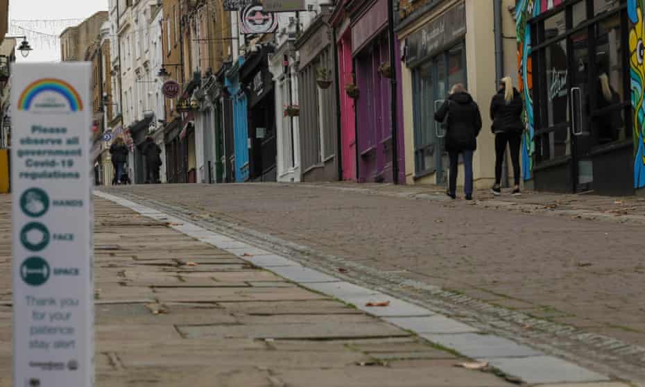 People walk past closed shops in Gravesend, Kent