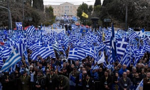 Demonstrators hold Greek flags during a rally outside parliament in Athens.