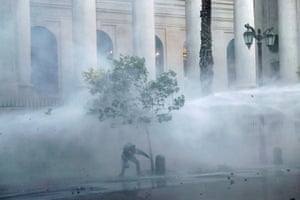 A jet of water is blasted during an anti-government protest in Santiago, Chile
