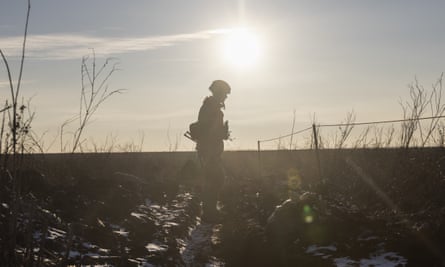 A Ukrainian soldier walks on the line of separation from pro-Russian rebels, in Mariupol, Donetsk region, Ukraine