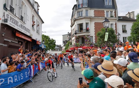 A group of cyclists climbs to the top of Montmartre during the men’s cycling road race