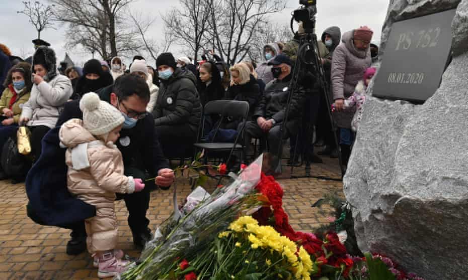 A man lays flowers during a commemorative ceremony with relatives, friends and colleagues of the crew and passengers of Ukraine International Airlines Flight 752, shot down in Iran a year before, on 8 January.