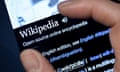 A person using Wikipedia on a phone.