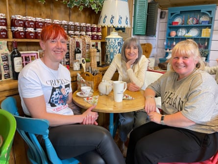 Three shop workers enjoy a coffee in a cafe