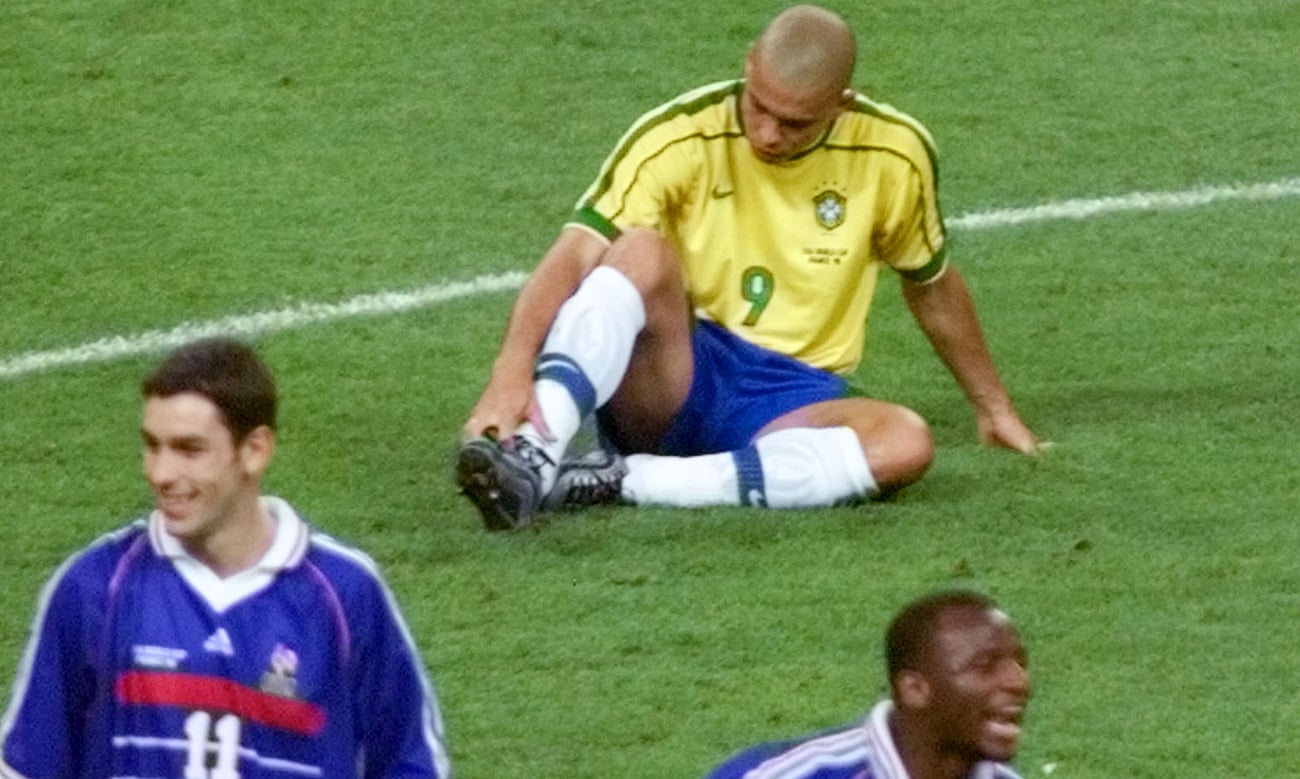 Ronaldo sits dejected on the pitch as Robert Pires of France and Patrick Vieira celebrate after the 1998 World Cup final.