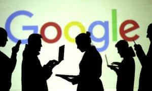 Users of laptop and mobile device users in front of a Google logo.