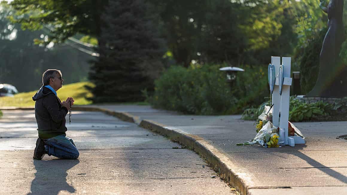 A mourner prays outside the Annunciation church in Minneapolis.