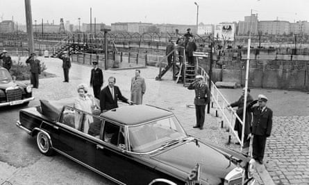 Queen Elizabeth II and Prince Philip, the Duke of Edinburgh. Pictured here passing the Berlin Wall in the Potsdamer Platz , Berlin in an open top car, 27 May 1965