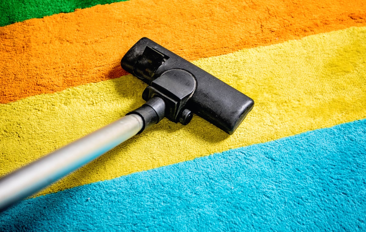 A vacuum cleaner on a colourful stripe carpet.