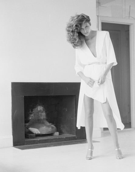 woman stands by fireplace