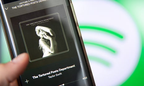 A smartphone displaying Taylor Swift's new album The Tortured Poets Department on Spotify.
