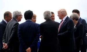 Donald Trump speaks with fellow G7 leaders at the summit in Taormina.
