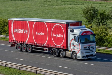 A Uniserve delivery truck driving down an A road