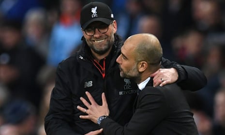Liverpool manager Jurgen Klopp (L) embraces Manchester City manager Pep Guardiola after the match ended in a 1-1 draw