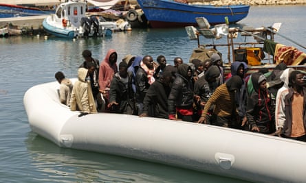 People heading to Europe are brought back to the port after being intercepted in the Mediterranean Sea by the Libyan coastguard, in Gasr Garabulli, north-western Libya.