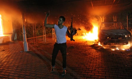 An armed man before the blazing US consulate in Benghazi, 11 September 2012.