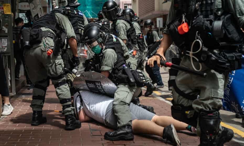 A man is detained by Hong Kong riot police during a demonstration on Wednesday