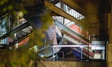 The collapsed balcony at the housing complex is seen with twisted metal and deformed structure