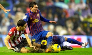 Lionel Messi in the thick of the action with Athletic’s Ander Herrera in the rain in 2011.