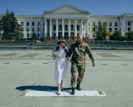 Tetiana and Oleksandr step on to the wedding rushnyk, a traditional embroidered cloth. The ritual symbolises the start of the couple’s life together