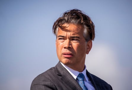 a man in a suit looks off to the side