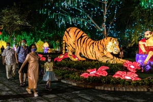 People walk past the Chinese New Year decorations at the Fo Guang Shan Dong Zen Temple in Jenjarom outside Kuala Lumpur, Malaysia.
