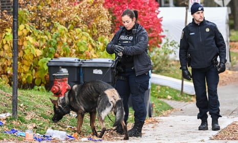 Police search an area near the Yeshiva Gedolah Jewish school after shots were fired at the school in Montreal, Sunday, 12 November 2023.