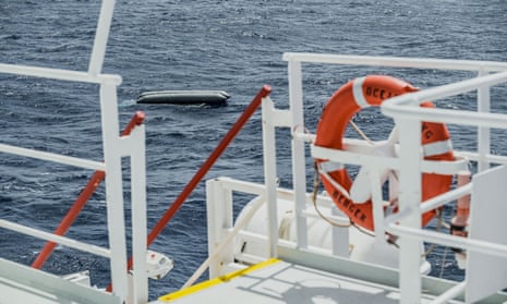 A rubber boat is seen after it capsized in the Mediterranean