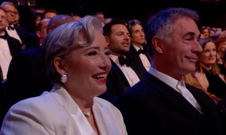Emma Thompson watches with a supportive smile.