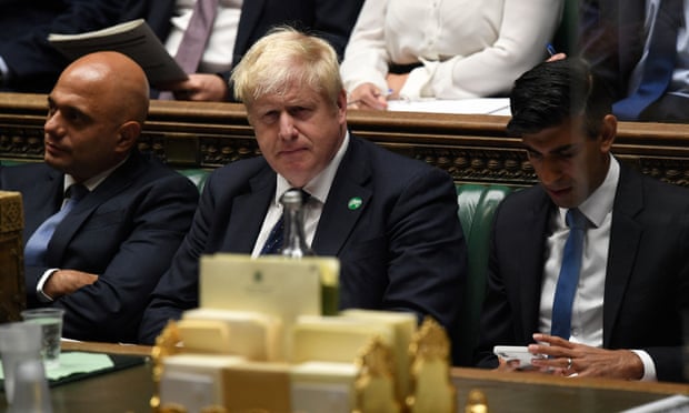 Boris Johnson, flanked by Sajid Javid and Rishi Sunak, pictured last year. Both senior minister resigned on Tuesday.