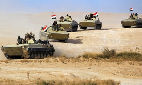 FILES-IRAQ-CONFLICT<br>(FILES) In this file photo taken on November 25, 2017, armoured personnel carriers (APCs) of the Iraqi forces and the Hashed al-Shaabi (Popular Mobilisation units) advance through Anbar province, 20 kilometres east of the city of Rawah in the western desert bordering Syria, in a bid to flush out remaining Islamic State (IS) group fighters in the al-Jazeera region. - A US strike killed top Iranian commander Qasem Soleimani at Baghdad's international airport on January 3, 2020, dramatically heightening regional tensions and prompting arch enemy Tehran to vow "revenge". (Photo by AHMAD AL-RUBAYE / AFP) (Photo by AHMAD AL-RUBAYE/AFP via Getty Images)