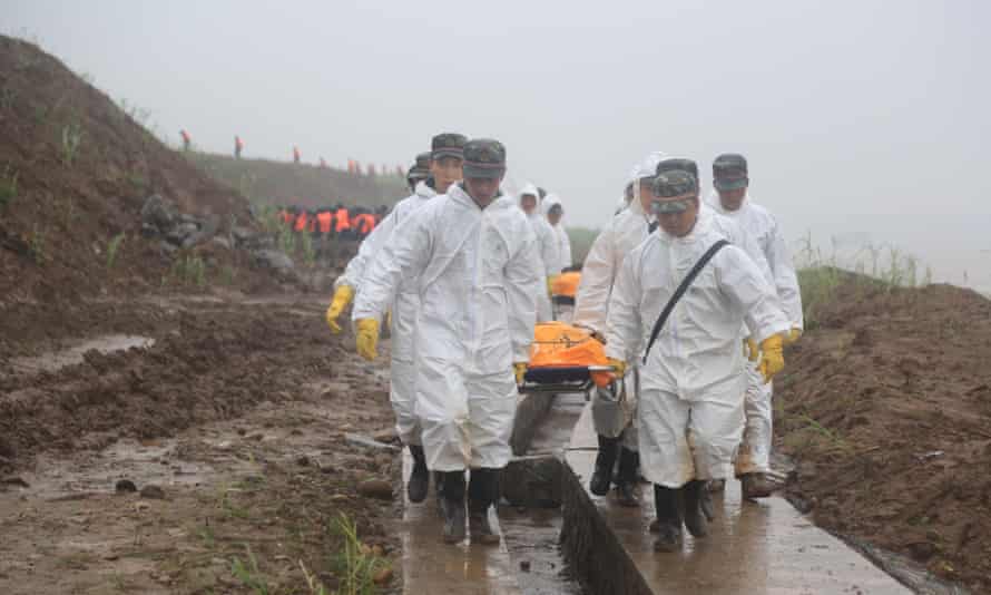 Rescuers carry victims’ bodies from the capsized ship Dongfangzhixing in the Yangtze River.