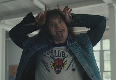 Joseph Quinn as Eddie Munson, making rocker devil-horns, in Stranger Things 4.
