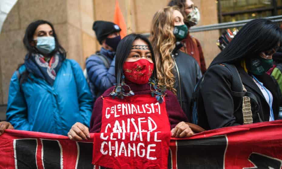 An indigenous Amazonian woman protests with Extinction Rebellion in Glasgow.