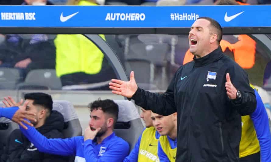 Hertha’s assistant coach Mark Fotheringham barks some instructions, probably in German.