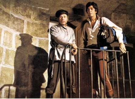 two men standing at top of staircase