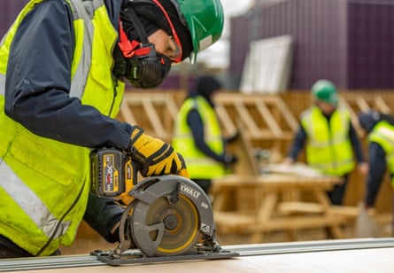 A construction apprentice doing some carpentry.