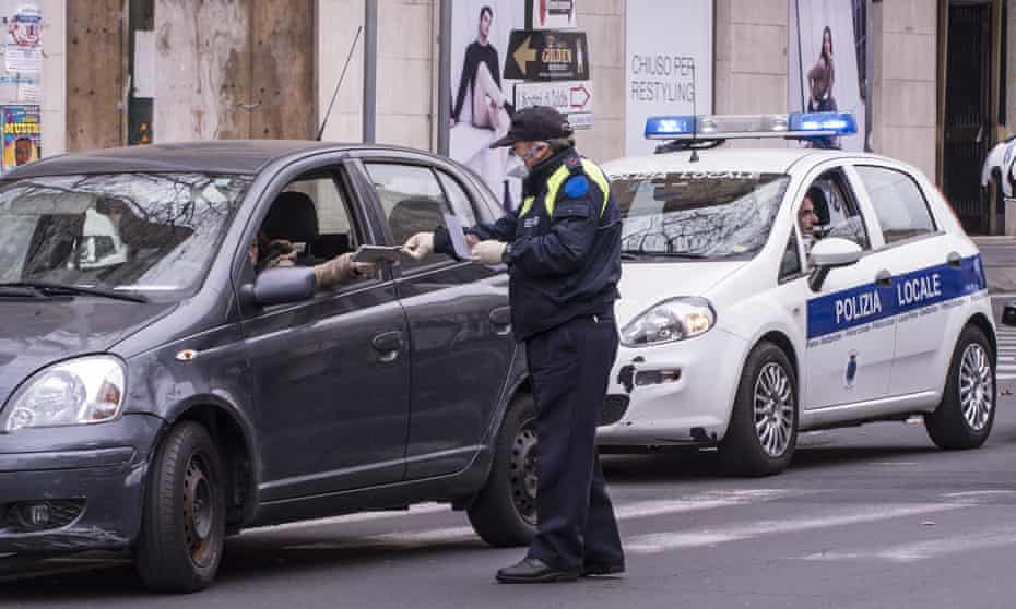 Police in Catania, Sicily, perform checks to try and contain the spread of coronavirus.