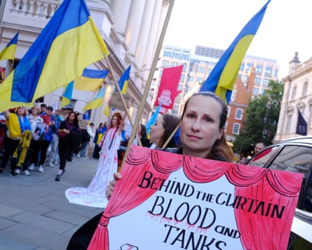 Oleksandra Vietrova holding a sigh outside the Royal Opera House
