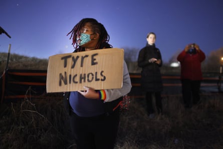 a person holds a sign that reads ‘Tyre Nichols’
