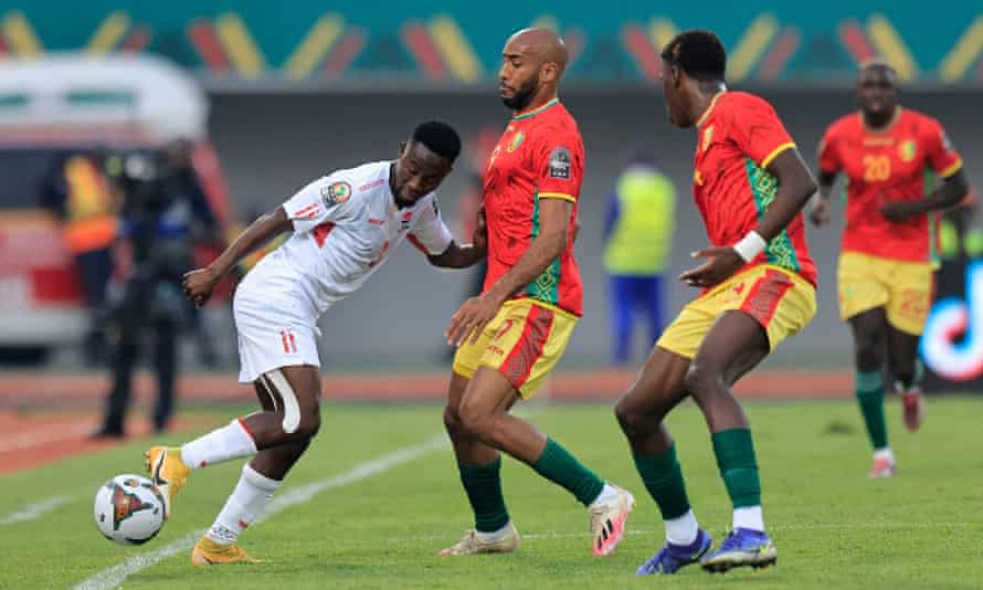 Gambia’s Ablie Jallow (left) is closed down by Guinea’s Jose Kante.