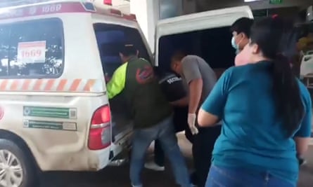 People gathered down an ambulance