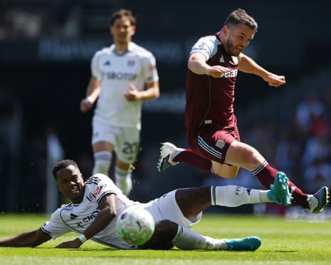 Fulham's Ryan Sessegnon slides in to challenge Aston Villa's John McGinn.