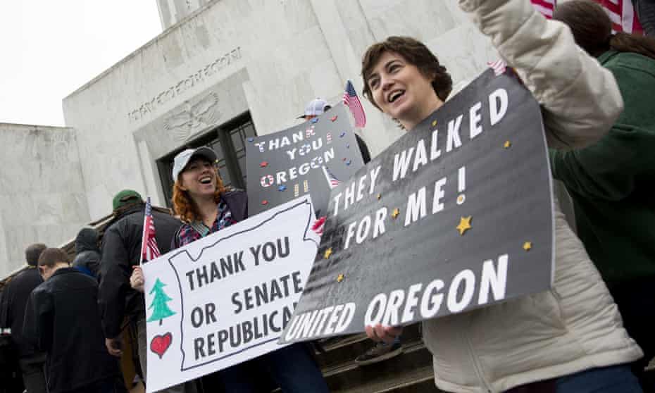 Protesters Bridgette Rappoport and Tkeisha Wydro gather outside the Oregon state house in Salem.